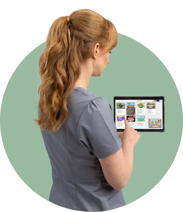Clinical specialist using the REAL System tablet that displays rehabilitation experiences