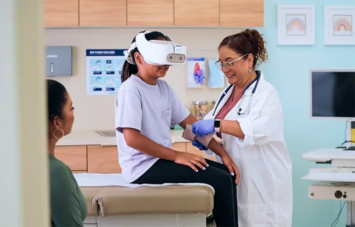Doctor helping child with REAL System VR Headset on