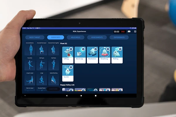 A tablet showing a TherapyView screen from REAL System's y-Series, allowing a PT to select the exercises for a patient to use.
